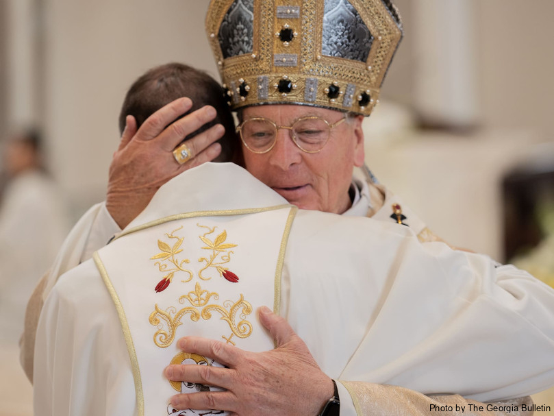 Archbishop Gregory John Hartmayer, OFM Conv., greets Father David DesPres during the Mass of ordination at Holy Vietnamese Martyrs Church. Photo by Johnathon Kelso