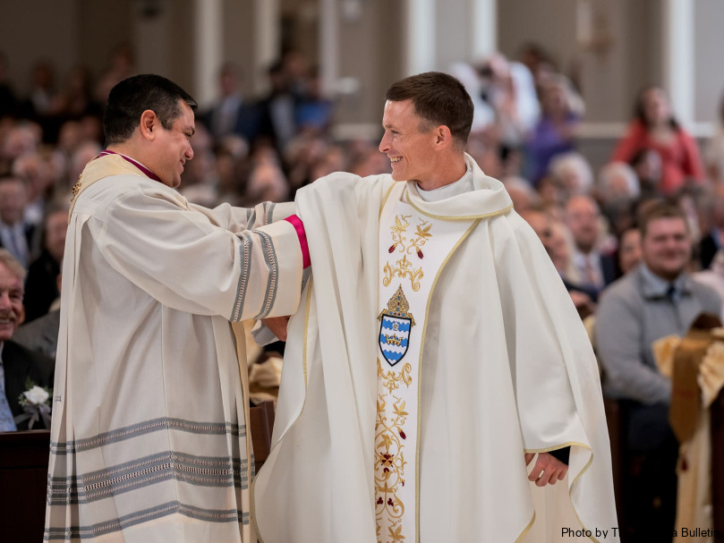 Father Gerardo Ceballos-Gonzalez assists Father Colin Patrick vest with the stole and chasuble during the ordination of the priesthood at Holy Vietnamese Martyrs Church in Norcross. Photo by Johnathon KelsoFather Gerardo Ceballos-Gonzalez assists Father Colin Patrick vest with the stole and chasuble during the ordination of the priesthood at Holy Vietnamese Martyrs Church. Photo by Johnathon Kelso