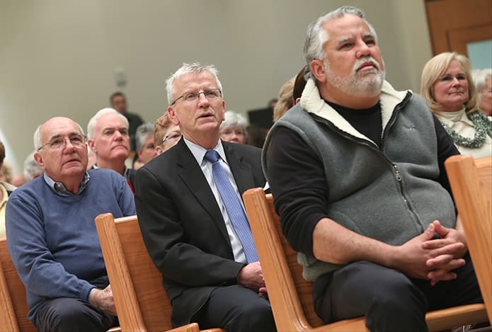 (Foreground to background) Mario Arguello, Gary Jones Jerry Topinka were among the hundreds of parishioners who came together, for not only the rededication of the renovated sanctuary, but the 40th anniversary of the parish and the 10th anniversary of the church’s presence in Flowery Branch. Photo By Michael Alexander