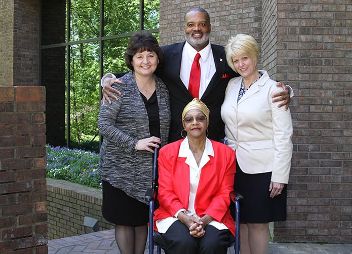 Carlton Byrd, top center, and his mother Jeannie, bottom center, join Diane Starkovich Ph.D., left, superintendent of schools, and Rebecca Hammel, associate superintendent of schools at the Atlanta Archdiocese Chancery. Byrd, a retired DeKalb County water meter reader and a 1978 graduate of St. Thomas More School, Decatur, was so grateful for his Catholic education, in 2015 he made contributions, totaling $7,010, to 21 of the 25 Catholic schools in the Archdiocese of Atlanta. Photo By Michael Alexander