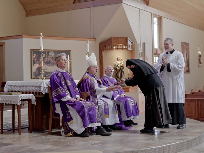 Sister Maria Pia from St. Joseph Church in Marietta hands Bishop Joel M. Konzen, SM, the Book of the Elect during the Rite of Election in Kennesaw. Photo by Johnathon Kelso