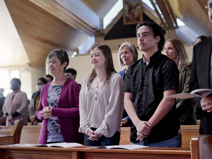 Participants in the March 5 Rite of Election at St. Catherine of Siena Church stand as their names are read aloud. There are 489 catechumens and 914 candidates becoming Catholics in Atlanta.