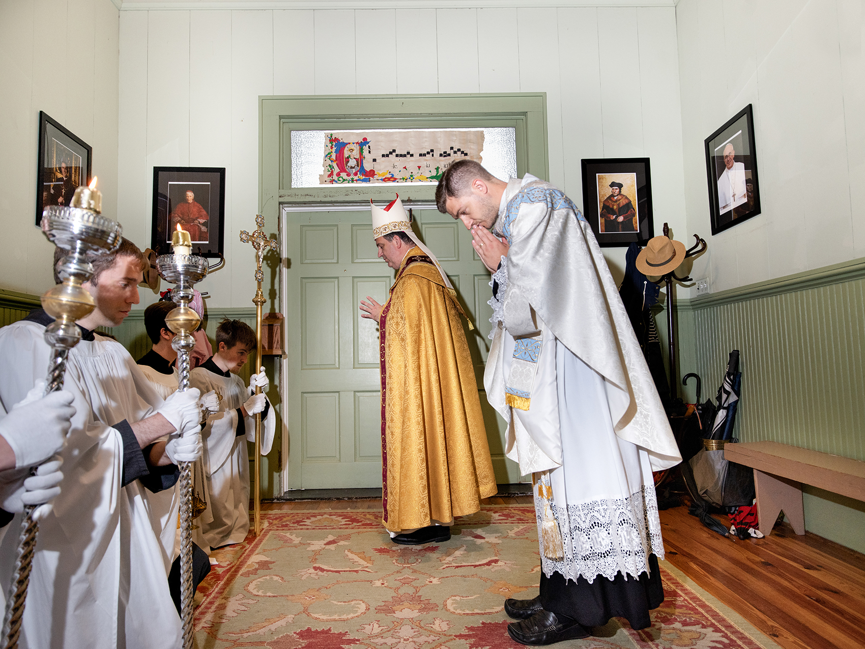 Bishop Steven J. Lopes of the Ordinariate of the Chair of Saint Peter, and Father Gregory Tipton, pastor of St. Aelred Church, bow before the processional cross concluding the Mass during the Feast of Corpus Christi. Photo by Johnathon Kelso