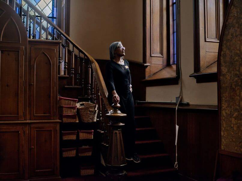 Parishioner Betty Derrickson pauses during her day while preparing the sanctuary for Mass at the Shrine of the Immaculate Conception. Photo by Johnathon Kelso