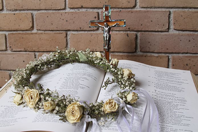 The veil worn by Sister Mary Beatrice Raphael during her Aug. 15 consecration or simple profession rests on the open pages of the Bibleâs Song of Songs, chapters 5, 6 and 7. Her spiritual advisor suggested that she read it during the eight-day retreat before her profession. Photo By Michael Alexander