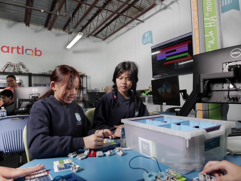 Elizabeth Cing and Veronica Nuam work inside the Smartlab at St. Peter Claver Regional School. Photo by Johnathon Kelso