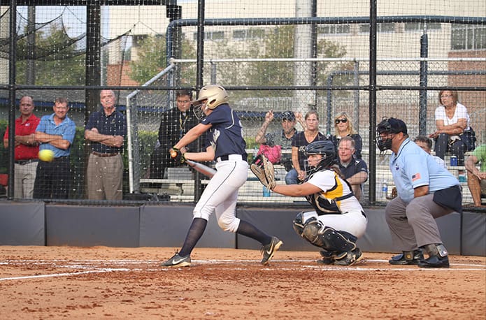 St. Pius X junior Kasey Ketner hits a deep sacrifice fly to the outfield during the fifth inning to bring over the teamâs second run. Photo By Michael Alexander