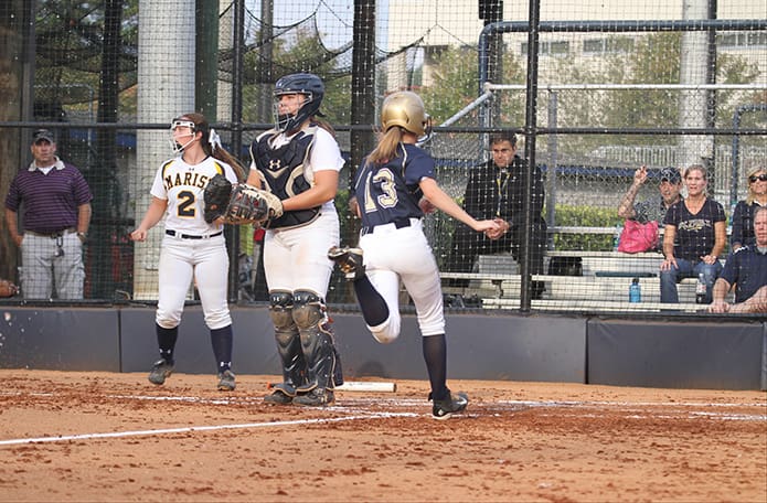 Senior outfielder Lorette Edwards (#13) scores St. Piusâ second run after Kasey Ketnerâs sacrifice fly. Photo By Michael Alexander