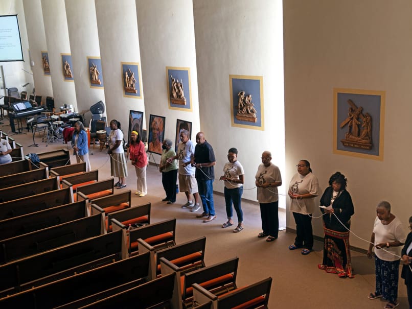 The parish community at Sts. Peter and Paul Church prays a living rosary together during the Sojourning On the Road to Sainthood event. Photo by Johnathon Kelso