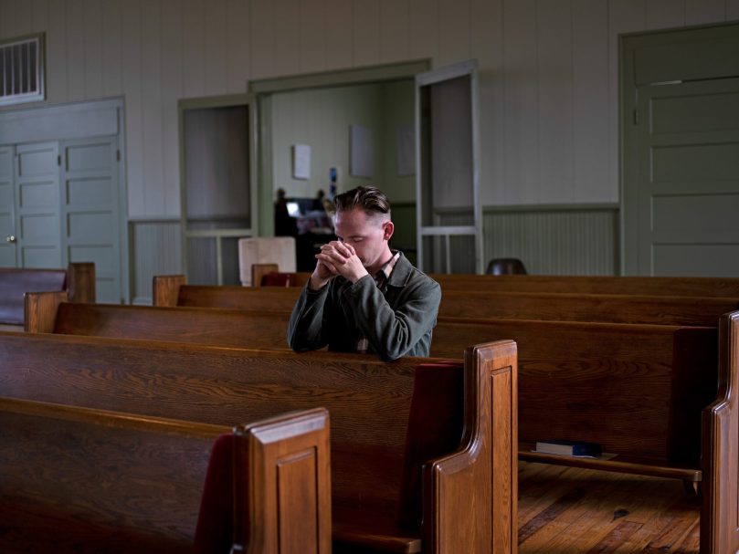 A St. Aelred parishoner prays before Mass on March 19. Photo by Johnathon Kelso