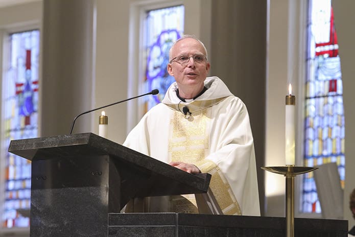 Father Dan Fleming, pastor of St. Andrew Church, Roswell, thanks the many committees and people who made the renovation and rededication service possible. Photo By Michael Alexander