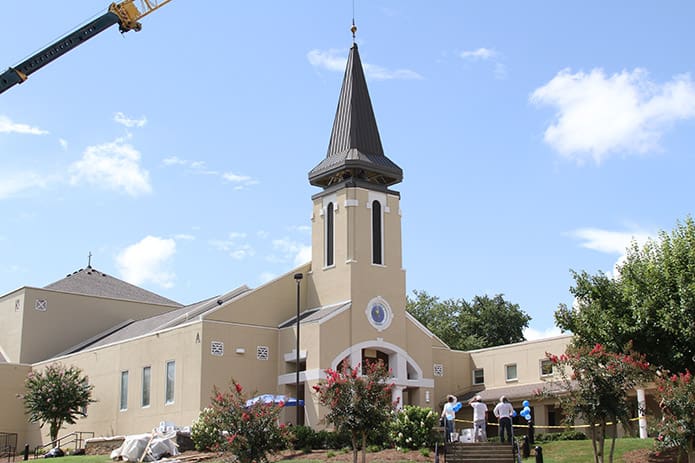 With the 70-75 ton all terrain link-belt crane, the cupula is set in place over St. Andrew Church. Photo By Michael Alexander