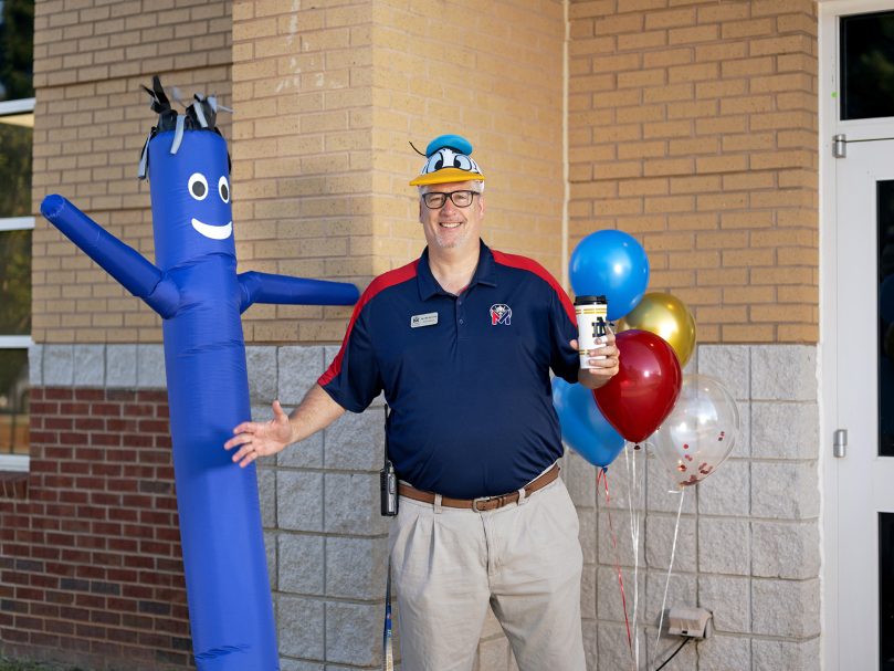 Athletic Director Bill Schmitz welcomes students to St. Mary's Academy in Fayetteville. Photo by Johnathon Kelso