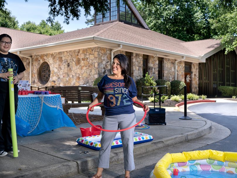 Director of Parish Enagagement Maria Yactayo tries out some of the fun activities offered to parishioners at the anniversary celebration of St. Thomas Aquinas Church. Photo by Johnathon Kelso