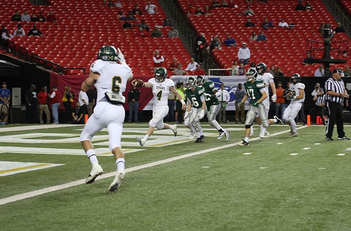 A 49-yard run by senior running back Garrett Dupuis (#4) set up his 10-yard romp for a Blessed Trinity touchdown and a 17-9 lead with 5:36 left in the third quarter. Photo By Michael Alexander