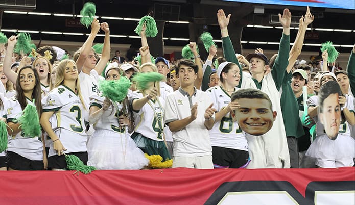 Fans signal touchdown and cheer after quarterback Conor Davis scored from 1-yard out with 6:25 remaining in the fourth quarter to give Blessed Trinity a 31-17 lead.