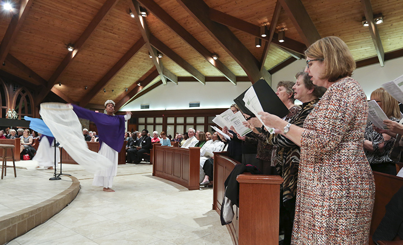 St. James United Methodist Church liturgical dancers, Megan Onubogu and Makeda Bryce, accompany the Alpharetta Community Choir, as they sing the traditional spiritual “Down to the River to Pray.” The choir was comprised of vocalists from Alpharetta Presbyterian Church, St. Aidan’s Episcopal Church, St. James United Methodist Church and St. Thomas Aquinas Church. Photo By Michael Alexander