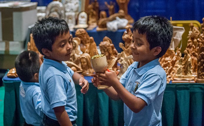 Abraham and Erick Emanuel Martinez, both 7, examine the religious gift items available for purchase in the exhibitors' hall at the 2017 Eucharistic Congress. Photo by Thomas Spink