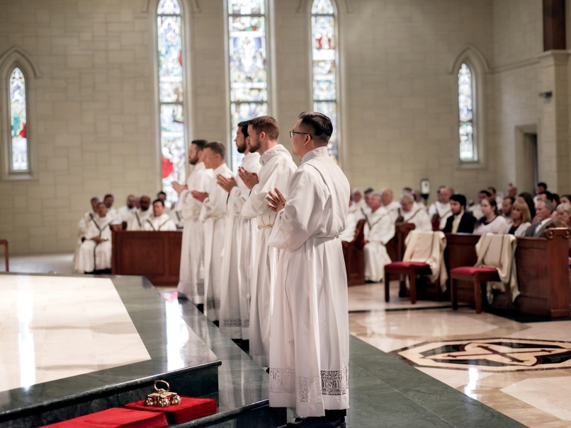 Seminarians come forward as Archbishop Gregory Hartmayer, OFM Conv., declares that he has chosen them to be ordained to the transitional diaconate/ The May 20 ordination Mass was held at St. Peter Chanel Church, Roswell. From left to right, Jared Kleinwaechter, Colin Patrick, Arturo Merriman, David DesPres and Joseph Nguyen. Photo by Johnathon Kelso