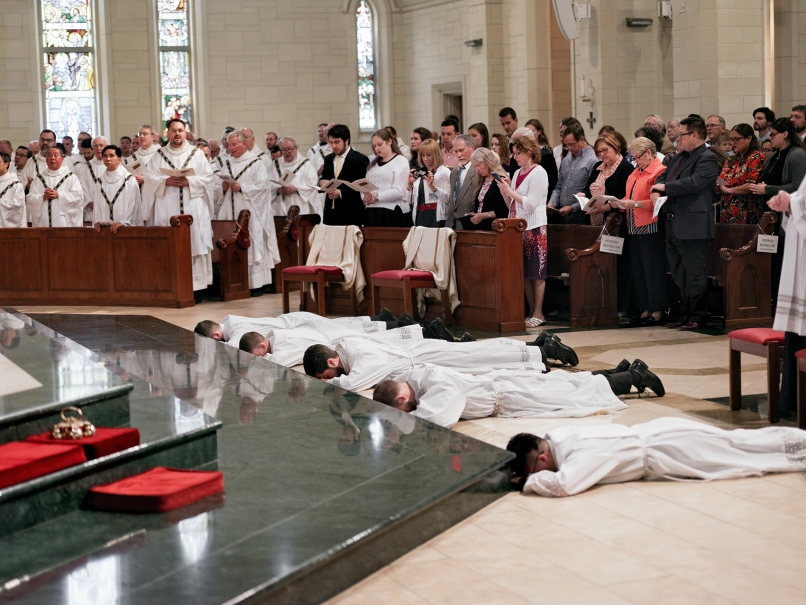 Archbishop Gregory Hartmayer, OFM Conv., lays hands on Arturo Merriman during the Mass of ordination to the transitional diaconate held at Rowell's' St. Peter Chanel Church. Photo by Johnathon Kelso