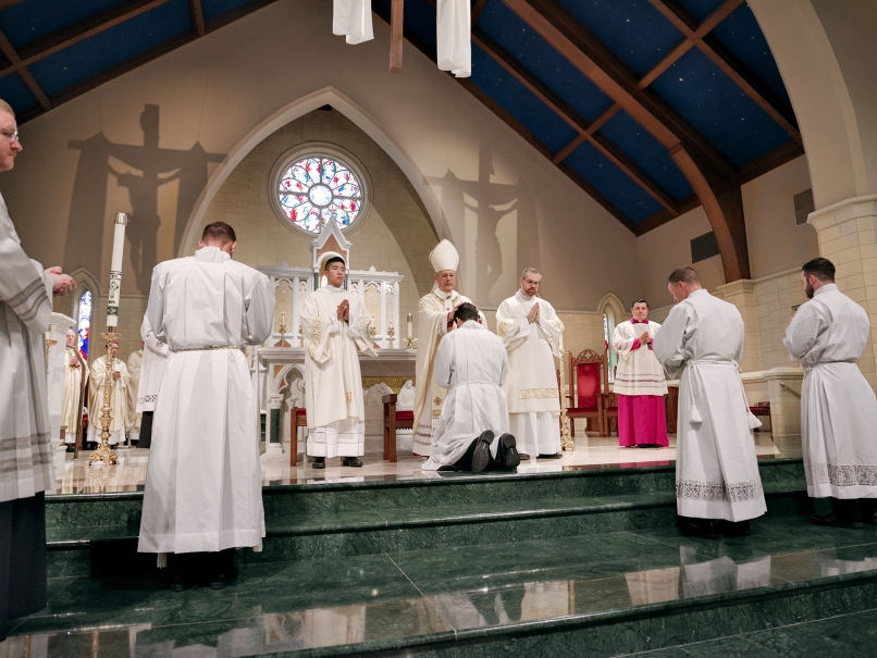 Archbishop Gregory Hartmayer, OFM Conv., lays hands on Arturo Merriman during the Mass of ordination to the transitional diaconate held at Rowell's' St. Peter Chanel Church. Photo by Johnathon Kelso