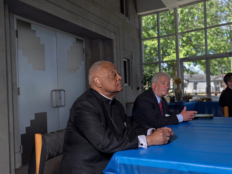 Cardinal Wilton Gregory, left,  and Rabbi David Straus listen to a speaker at the Lyke House in Atlanta May 9 during the Consultation of Representatives of the National Council of Synagogues and the U. S. Conference of Catholic Bishops. Photo by Johnathon Kelso