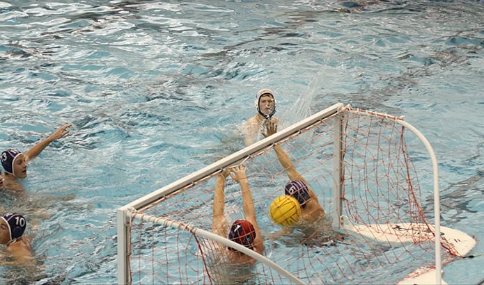 St. Pius senior Jack King fires a goal-scoring shot in between the outstretched hands of two Norcross players with 1:05 left in the third quarter to give Pius a 10-9 lead. He also scored a goal with 57 seconds left in the second overtime period to tie the score up at 14 apiece. Norcross scored first in the sudden death overtime to advance to the finals. Pius defeated Southern Crescent 12-6 to capture the third-place trophy. Photo By Michael Alexander