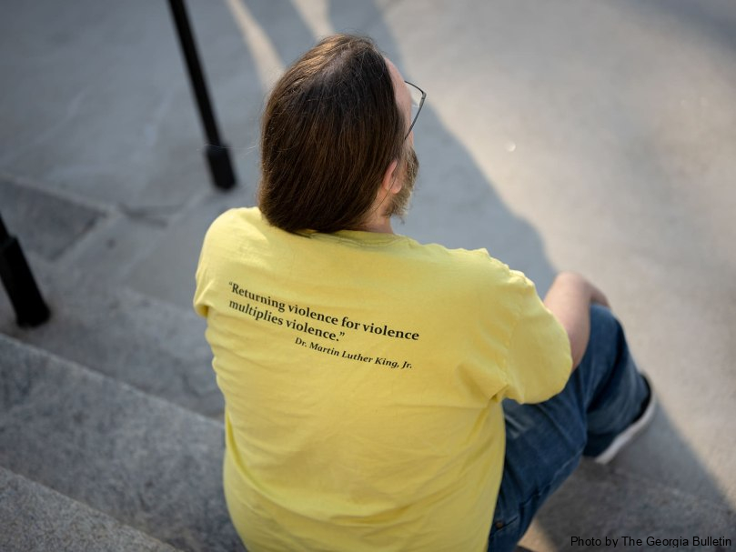 Ben Minor of the Southern Center for Human Rights sits on the steps of the Georgia State Capitol on the evening of the execution of Willie James Pye. Photo by Johnathon Kelso