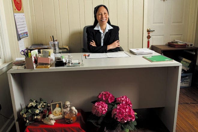 Sister of the Good Shepherd Christine Truong My Hanh sits at the desk in her Chamblee office, across from the couch where she counsels and listens to clients. Among the items at the base of her desk is a photo of her order’s foundress, Sister Mary Euphrasia.