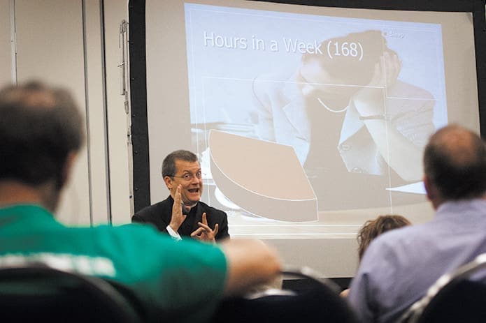 Msgr. Glenn Nelson presents to his audience using American Sign Language, June 1.