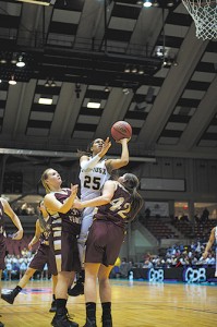 Asia Durr splits two Dawson County defenders in the AAA state championship game, won by St. Pius X High School, Atlanta.