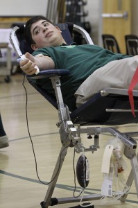 Blessed Trinity High School senior Matt Klein donates a pint of blood during the school's Jan. 25 blood drive. Klein, a first-time donor, said it was “easy and painless.”