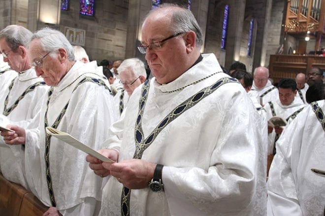 St. Benedict Church, Johns Creek, renews his priestly commitment during the March 26 Chrism Mass. Photo by Michael Alexander