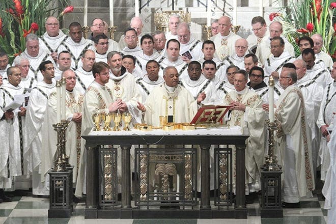 Archbishop Wilton D. Gregory, center, is joined at the altar by his brother clergy during the Liturgy of the Eucharist. Photo by Michael Alexander