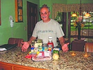 Don Reich, first-place entrée winner, shows off what he needs to make his tasty home-style crockpot baked beans with meat and vegetables. 