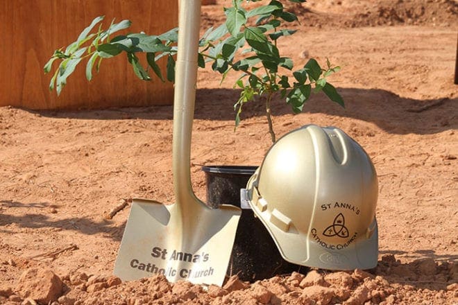 A shovel, construction helmet, and Crape Myrtle tree mark the groundbreaking of St. Anna Church, Monroe. Photo By Michael Alexander