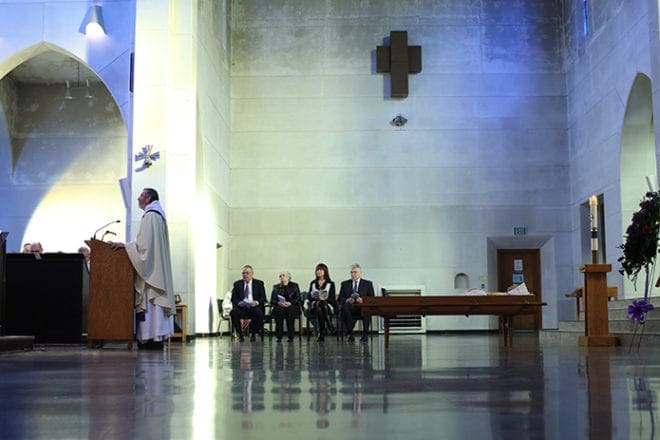 Abbot Francis Michael Stiteler, standing, Monastery of the Holy Spirit superior, reflects on the good times surrounding the life of Cistercian Father Luke Kot. The 102-year-old monk, who died Jan. 9, came to Conyers in 1944 when the Trappist monastery was founded. 