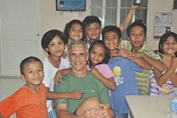 Transfiguration parishioner Dr. Jay Brunette visits with a group of Lingap Center children during a trip to the Philippines. The center is located in Toldeo City, Cebu, Philippines, and serves orphans and street children ages 6 to 18. 