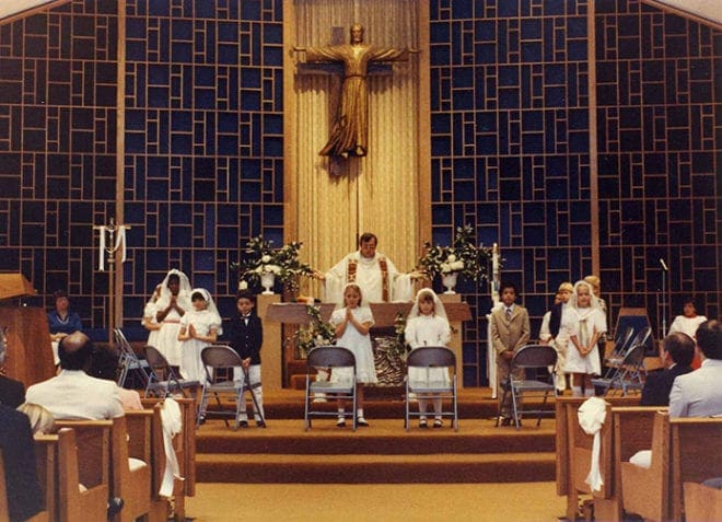 Father Alan Dillmann, who served as Holy Spirit's pastor from 1981 to 1987, celebrates first holy Communion. Photo Courtesy of Holy Spirit Church