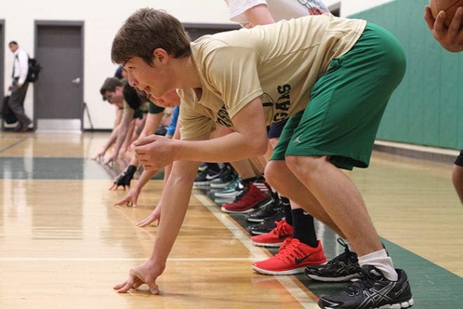 Right tackle Chris Bell, foreground, and his Holy Spirit Preparatory School football teammates prepare to run sprints from a three-point stand in the school’s gymnasium last February. The team participated in winter workouts from December to April, three days a week, from 6 a.m. to 7:30 a.m. Photo By Michael Alexander