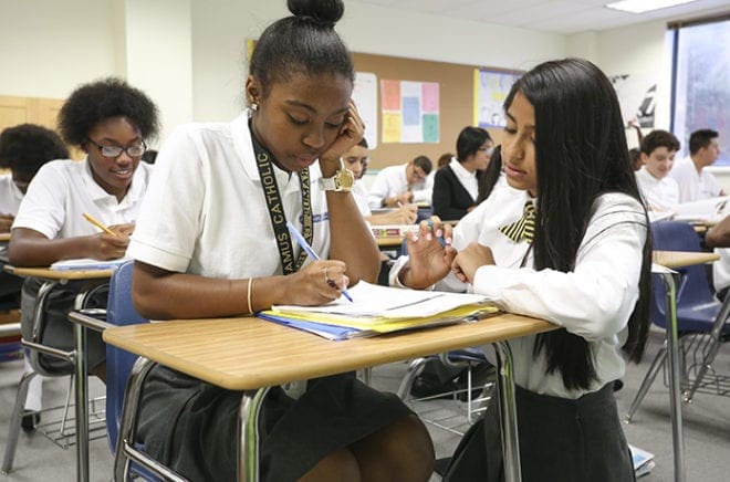 Bethy Ramirez-Sanchez, right, and Anyea Hampton look over a word problem together during their fourth-period math class. Photo By Michael Alexander