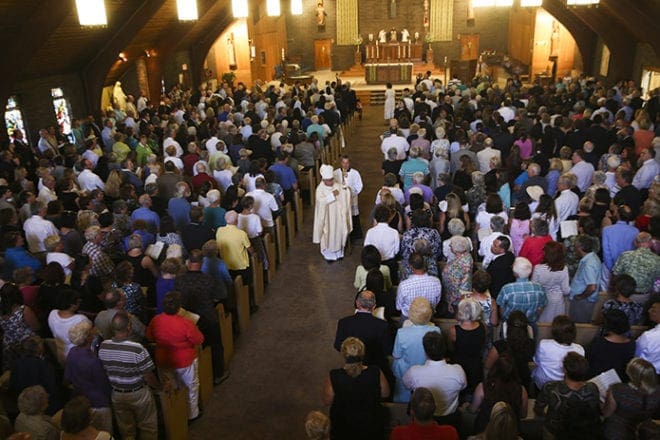 Bishop Peter A. Libasci of Manchester, N.H., walks down the aisle of Our Lady of the Holy Rosary Church in Rochester, N.H., following the Aug. 24 memorial service for slain U.S. journalist James Foley. Foley was seen being executed in a video released by Islamic State militants in Syria Aug. 19. CNS photo/Katherine Taylor, EPA