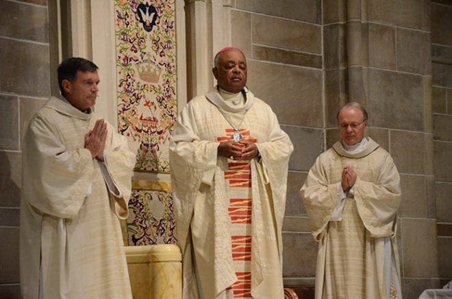 Archbishop Wilton D. Gregory, with Deacon Bill Garrett, left, and Deacon Gerald Zukauckas, celebrates Mass for the Deo Gratias Society and the Catholic Foundation of North Georgia Sept. 13. Archbishop Gregory blessed pins for each member of the society and thanked the members who have donated funds to make “good works possible.” Photo By Paige MacLane