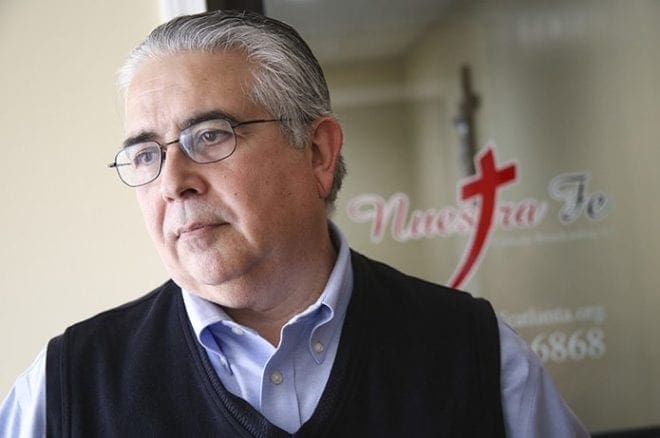 Cucho Garcia stands in front of the studio entrance to Nuestra Fe, the Spanish Catholic radio station at Our Lady of the Americas Mission in Lilburn. Garcia, who has been involved with the radio station for four years, describes himself as a “servant for the project.” Garcia is a member of St. Benedict Church in Johns Creek. Photo By Michael Alexander