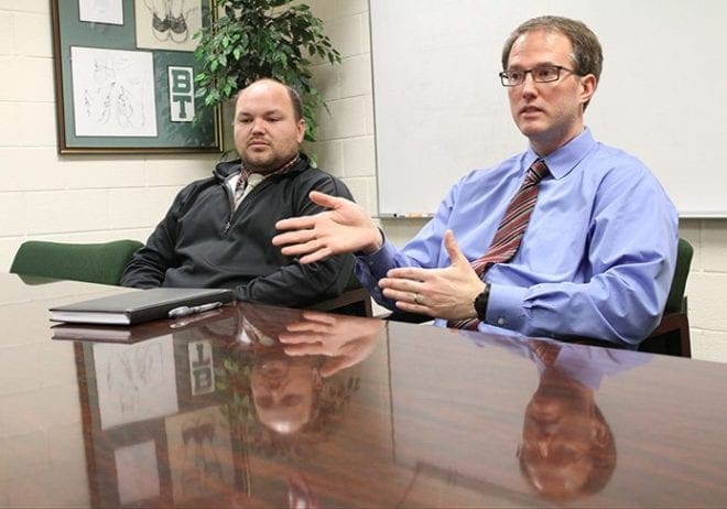 Jason Podhorez, right, computer systems administrator for Blessed Trinity High School, and Brent Hollers, part-time robotics teacher and part-time technology integration specialist, provide some details surrounding the technical work that went on behind the scenes to pull off the virtual school days trial last October. Photo By Michael Alexander