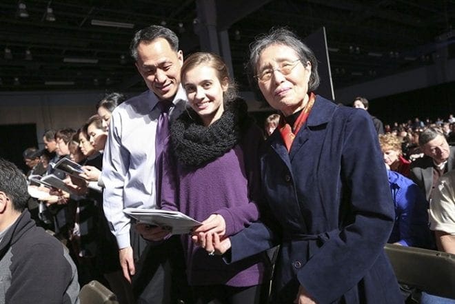 Catechumen Alisia Hahn, center, is joined by her father, Young, left, and her grandmother Agnes. The Hahns belong to Prince of Peace Church in Flowery Branch. Photo By Michael Alexander