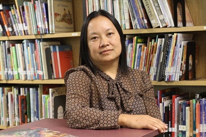 Theresa Mang, a member of the Burmese Catholic community at Corpus Christi Church, Stone Mountain, serves as a translator for the parents of the Burmese students at St. Peter Claver School in Decatur. She also tutors the children and helps with homework as needed. Photo By Michael Alexander