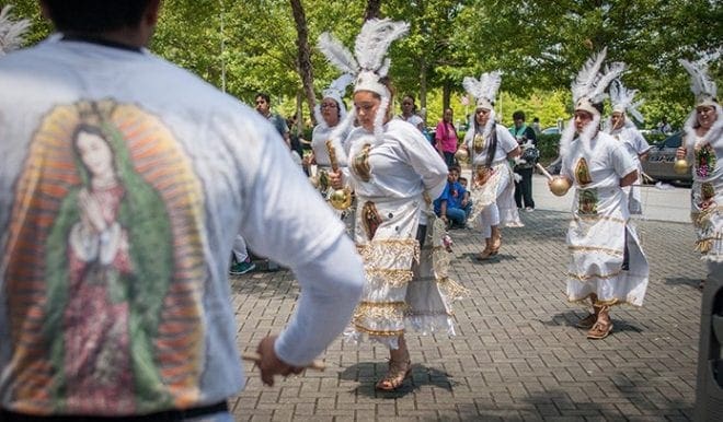 Drummer Jesus Chavez from St. Brendan the Navigator Church, Cumming, beats away at his drum at the Eucharistic Congress on Saturday, June 6. The St. Brendan’s group was one of a number of Hispanic dance groups in traditional garb. Photo By Thomas Spink