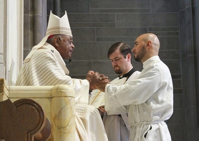 Carlos Cifuentes pledges his obedience to Archbishop Wilton D. Gregory and his successors. Like the other two transitional deacons ordained May 30, Rev. Mr. Cifuentes attends Mundelein Seminary, which is 40 miles north of Chicago. Photo By Michael Alexander