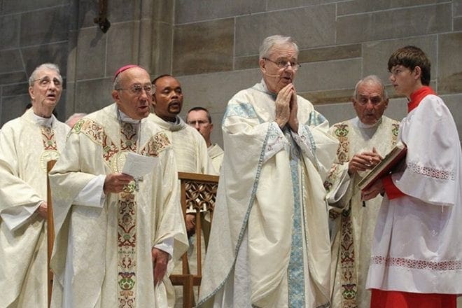 Father Richard Morrow, center, is the main celebrant for the May 31 Mass marking his 60th jubilee of priestly ordination. Among the many priests and friends concelebrating with Father Morrow, was Archbishop Eusebius Joseph Beltran, front row, left, archbishop-emeritus of Oklahoma City, Okla. Father Morrow and Archbishop Beltran became friends as seminarians when they worked together in the Savannah-Atlanta Diocese in the 1950s. Photo By Michael Alexander